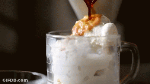 Coffee Is Being Poured Into A Glass Of Ice Cream And Whipped Cream GIF