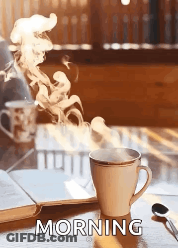 Coffee On Wooden Table Next To Book And Spoon GIF
