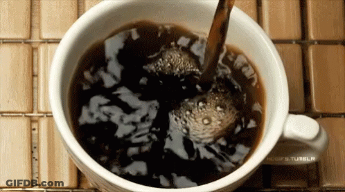 Coffee Poured Into Cup On Wooden Table GIF
