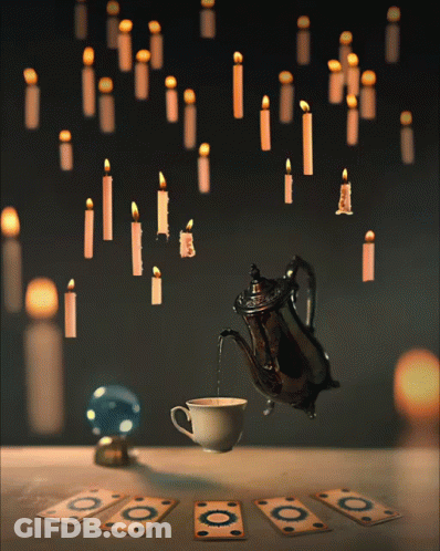 Coffee Poured Into Teapot With Hanging Candles GIF