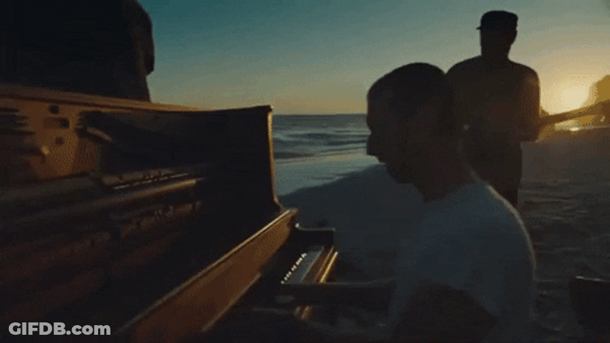Coldplay Performing On Beach At Sunset GIF