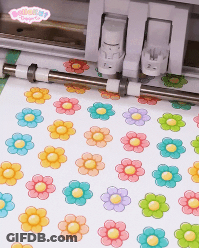 Colorful Flowers Cut Out Of Paper By Machine GIF
