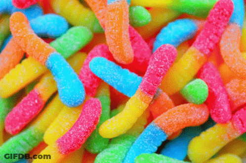 Colorful Gummy Worms Covered In Sprinkles GIF