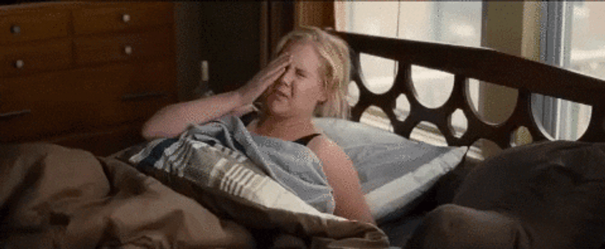 Comedian Amy Schumer Having Headache In Bed GIF
