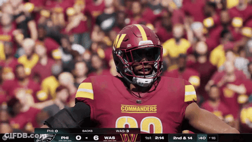 Commanders Football Player Standing In Front Of Crowd GIF