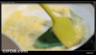 Computer Screen Showing Yellow Spoon Stirring Substance GIF