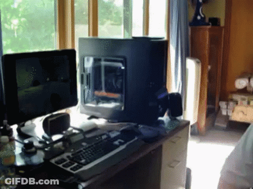 Computer Sitting On Desk Next To Keyboard GIF