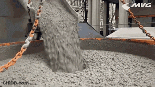 Concrete Is Being Poured Into A Large Container With The Word Mvg In The Corner GIF