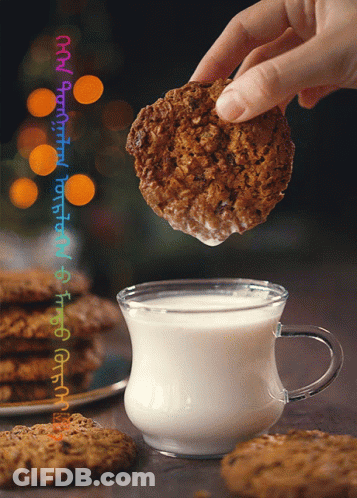 Cookie Dipped Into Glass Of Milk GIF