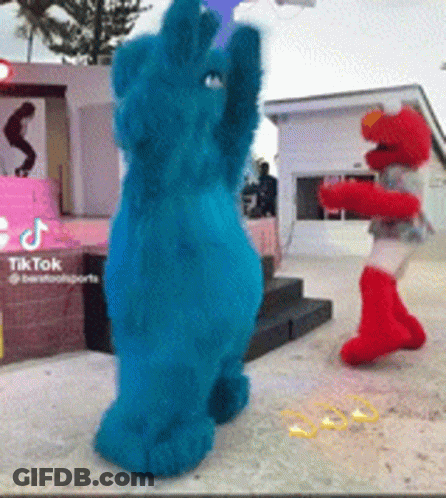 Cookie Monster And Elmo Dancing On Stage GIF
