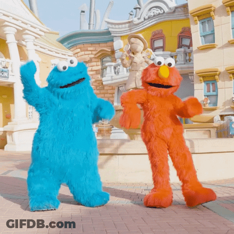 Cookie Monster And Elmo From Sesame Street Are Dancing In Front Of A Building GIF