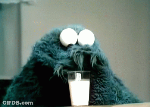 Cookie Monster Drinking A Glass Of Milk With Eggs In His Eyes GIF