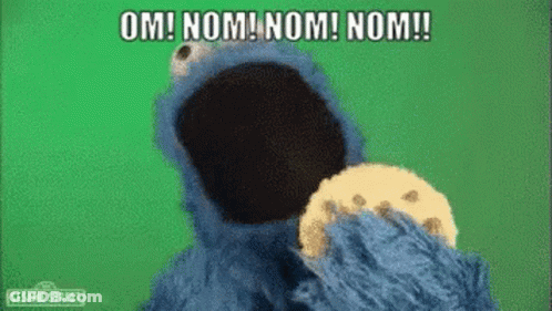 Cookie Monster From Sesame Street Is Eating A Cookie And Saying Om Nom Nom Nom ! GIF
