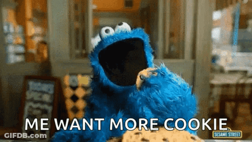 Cookie Monster From Sesame Street Is Eating A Cookie And Says Me Want More Cookie GIF