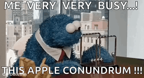 Cookie Monster From Sesame Street Is Sitting At A Desk With A Newton 'S Cradle In Front Of Him . GIF
