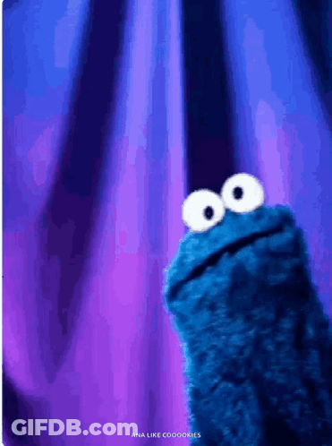 Cookie Monster From Sesame Street Looking Up At The Camera GIF
