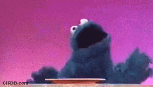 Cookie Monster Sitting On Table Looking At Plate GIF