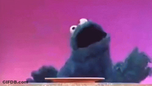 Cookie Monster Sitting On Table Mouth Open GIF