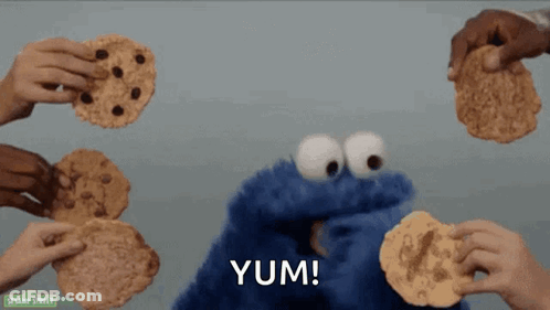 Cookie Monster Surrounded By People Holding Cookies GIF