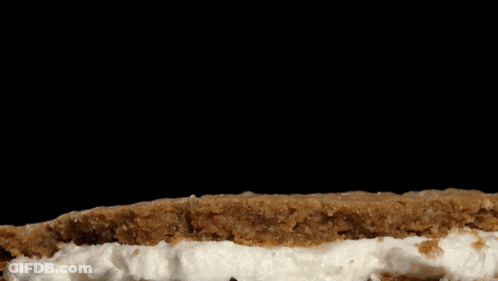Cookie With Whipped Cream On Black Background GIF