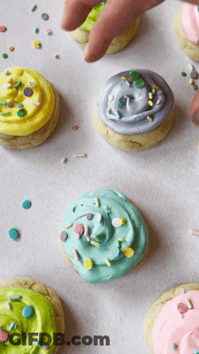 Cookies With Different Colored Frosting And Sprinkles GIF