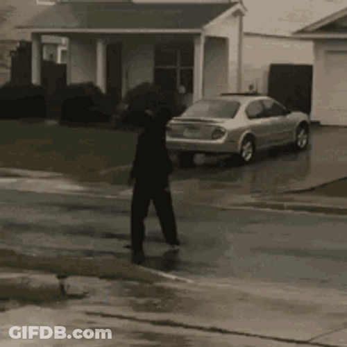 Cool Guy Playing And Dancing In The Rain GIF