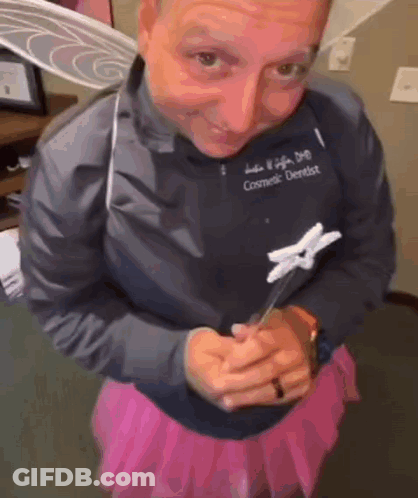 Cosmetic Dentist In Pink Skirt Holding Toothbrush GIF