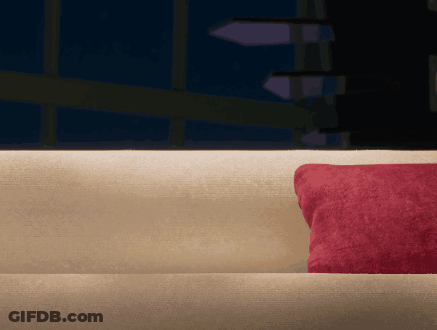 Couch With Red Pillow In Dark Room GIF