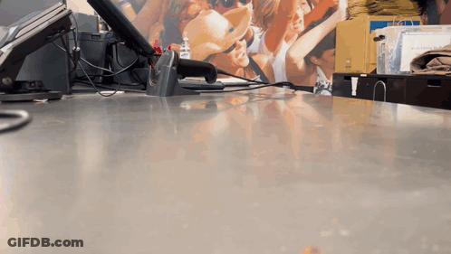 Counter With Scanner And People Picture On Wall GIF
