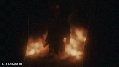 Couple Holding Hands In Front Of Fire GIF