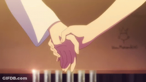 Couple Holding Hands In Front Of Piano With Candles GIF