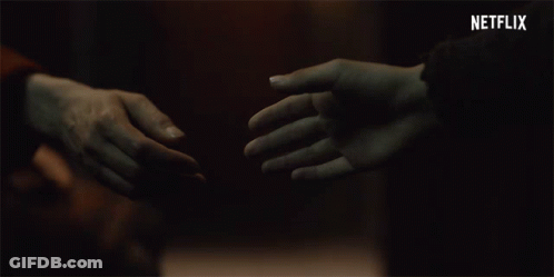 Couple Holding Hands With Netflix Logo GIF