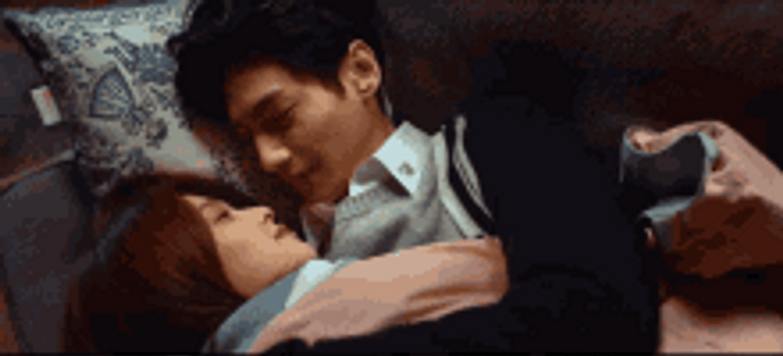 Couple In Bed Sweetly Kissing GIF