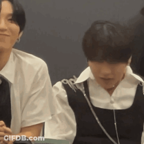 Couple In Black Vests, Man In White Shirt GIF