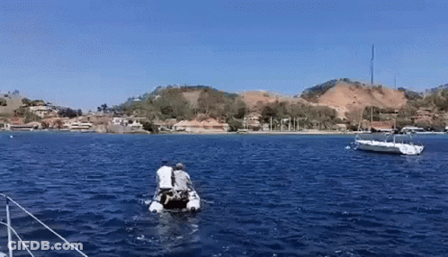 Couple In Small Boat In Ocean GIF