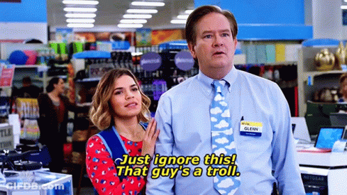Couple In Store With Tie Saying Just Ignore This GIF