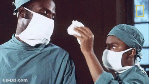 Couple In Surgical Masks With National Geographic Logo GIF