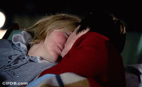 Couple Kissing In Car At Night Wearing City Sweatshirt GIF