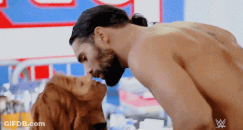 Couple Kissing In Front Of W Sign GIF