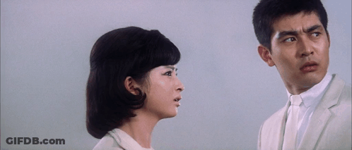 Couple Looking, Man In White Suit GIF