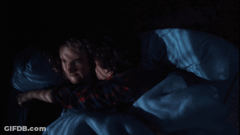 Couple Lying In Bed Saying Get Off Me In Red GIF