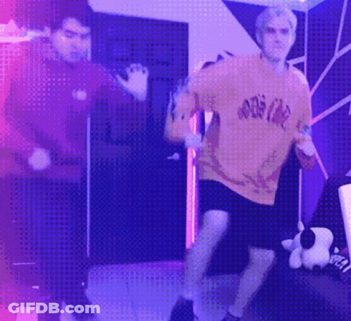 Couple Of Men Dancing In Purple Lights GIF