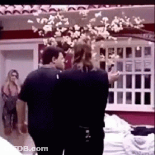 Couple Of People Standing Next To Each Other In Front Of Window GIF