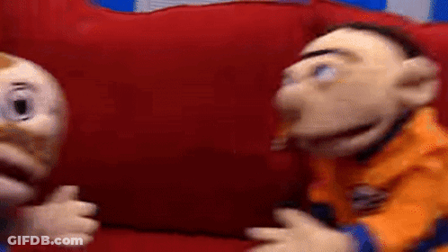 Couple Of Puppets On Red Couch GIF