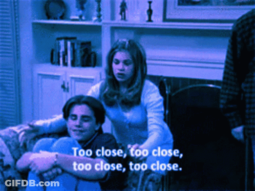 Couple On Couch Saying Too Close GIF
