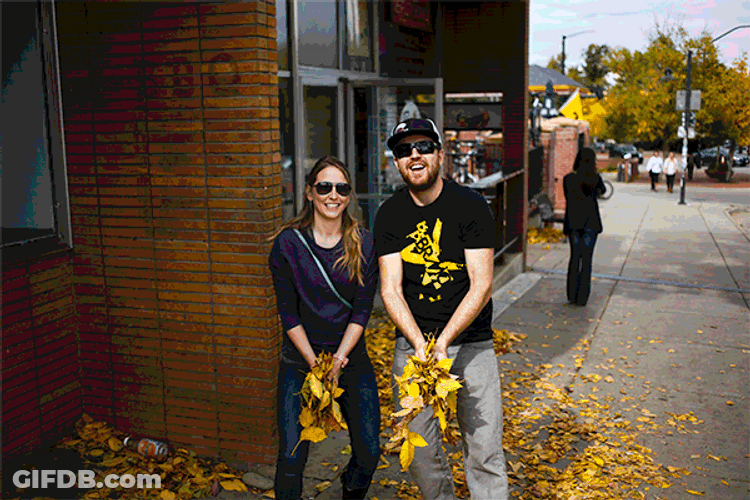 Couple Playing Fall Leaves GIF