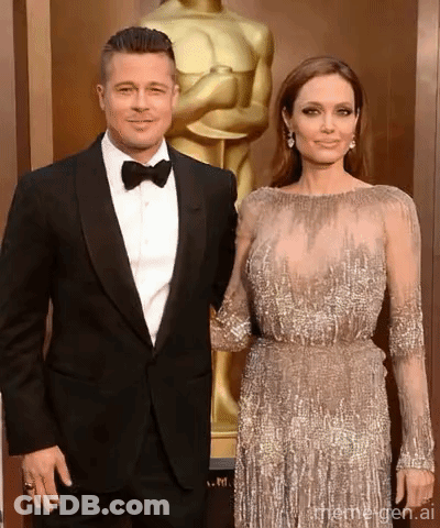 Couple Posing With Oscar Statue GIF