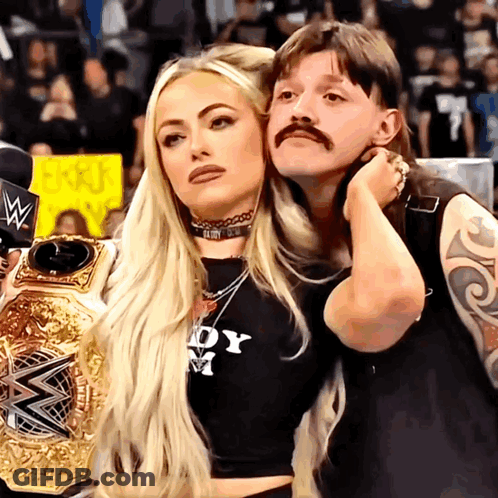 Couple Posing Woman In Black Shirt Lady M GIF