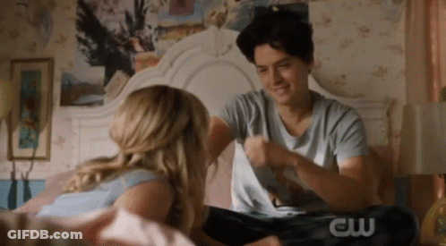 Couple Sitting On Bed Man Wearing CW Shirt GIF