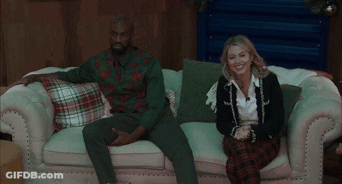 Couple Sitting On Couch With Plaid Pillows GIF
